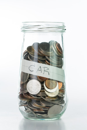 Saving money into bottle for cash in future investmentの写真素材