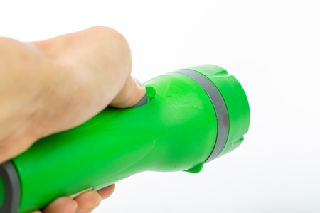 Green flashlight isolated with white backgroundの写真素材