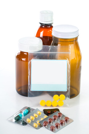 Pills and drug container isolated with white backgroundの写真素材