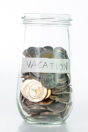 Saving money into bottle for cash in future investmentの写真素材