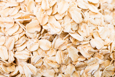 Macro Oat flakes pile on the white background