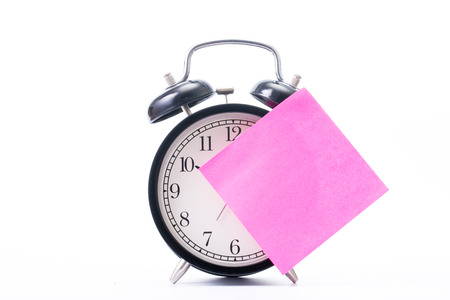Note color paper stick on  alarm clock for notice something with white background