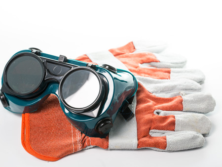 Construction gloves and goggles glasses isolated with white backgroundの写真素材