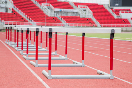 hurdles on the red running track prepared for competitionの写真素材