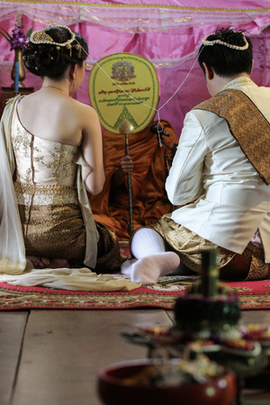 NAKRONPHATHUM THAILAND -JULY 6: Wedding ceremony July 6 2014, Thai couple listen and repect Monks  in Nakronphathum ,Thailand.のeditorial素材