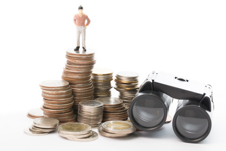 Businessman doll stand on top of binoculars in concept of show visionの写真素材