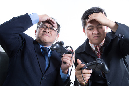 Two Business manager hold joystick for competition on white background の写真素材