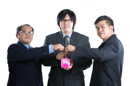 Businessman used hands for insert coin to piggy bank for deposit their investment in the futureの写真素材