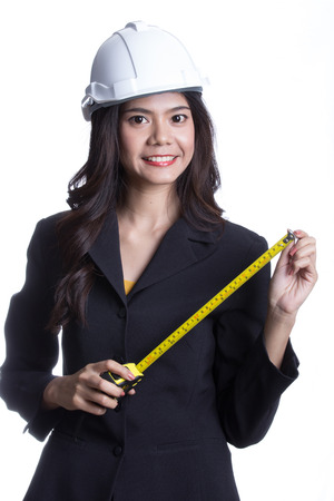 Asian Engineer women hold measure tape with white backgroundの写真素材
