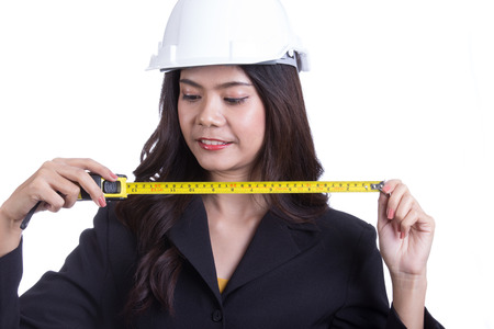 Asian Engineer women hold measure tape with white backgroundの写真素材