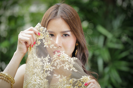 Wonderful Bride with wedding suit in the garden.の写真素材