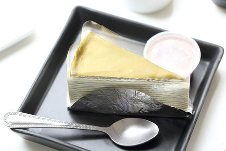 Piece of cake with milk jam in coffee shopの写真素材