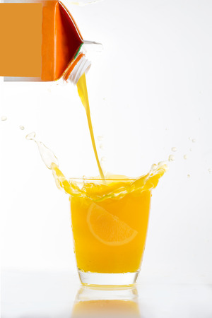 Orange juice splash prepare for breakfast in the morningの写真素材