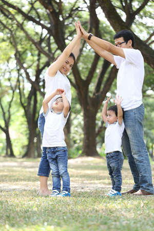 Family dream home cover their children in the gardenの写真素材