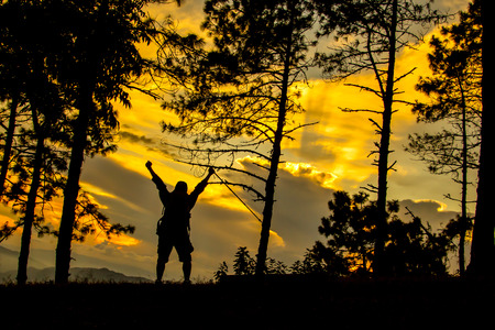 Silhoutte of man climbing and happy at terminal wayの写真素材