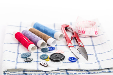 Yarn scissors ,measuring tape and Yarn Sewing with cloth backgroundの写真素材