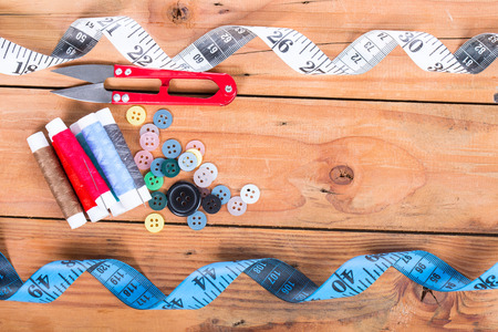 Yarn scissors ,measuring tape and Yarn Sewing with wood backgroundの写真素材