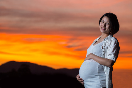 Pregnant ,Mam touch torso for feeling love their baby in home.の写真素材