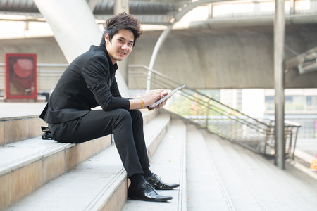 Businessman use tablet for search information and check report in the outsideの写真素材