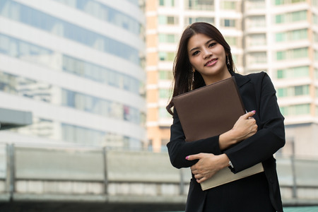 businesswoman holding document for check her job in the outsideの写真素材