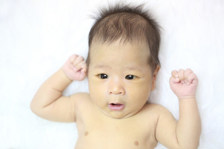 Asian baby hands raised up for strong and success conceptの写真素材