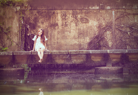 Portrait young adult post to photographer with Vintage toned color in the gardenの写真素材