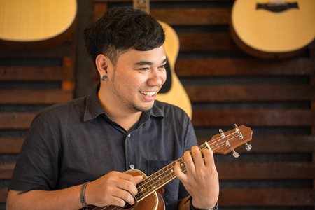 Ukulele Guitar teacher teach music in schoolの写真素材