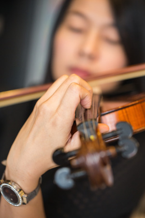 violinist playing violin musics in studio schoolの写真素材