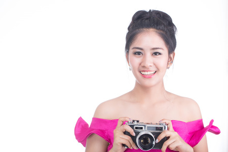 Young girl Photographer holding vintage camera with white background.の写真素材