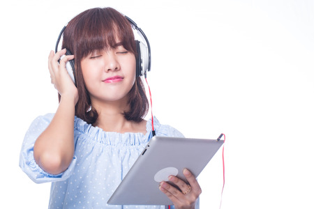 Music,Young woman holding headphones with white backgroundの写真素材