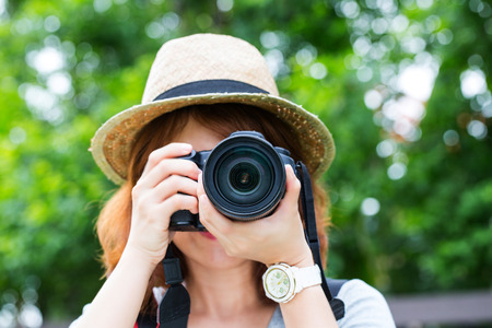 Young girl Photographer holding vintage camera with white background.の写真素材