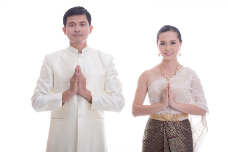 Thai Man and women welcome with traditional Thai suit in Studioの写真素材