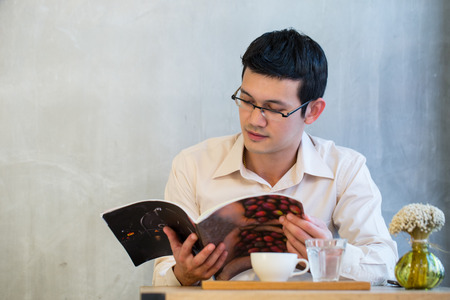 Young adult stand and smile with vintage wall in coffee shop