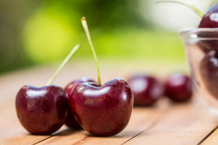 Sweet cherries on the table in garden.