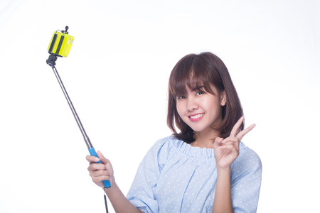 Young adult post for selfie with white background.の写真素材