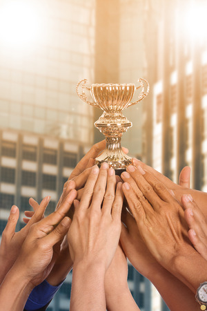 Success business with thier winner trophy holding by hands.の写真素材
