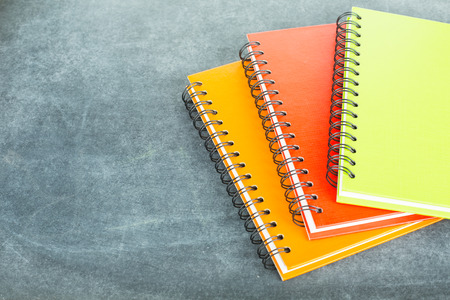 Colorful note book on the black board.の写真素材