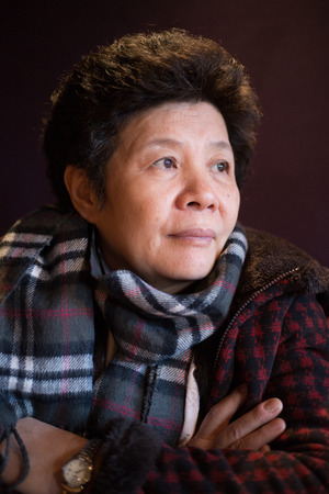 Asian senior woman portrait with window light.のeditorial素材