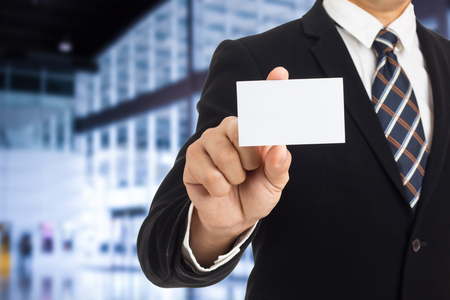 Businessman show business card for introduce himself.の写真素材