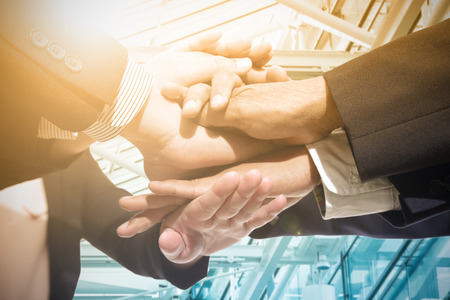 Touching hand team work in business office.の写真素材