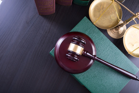 Wooden Judges gavel ,golden scales justice with black background.