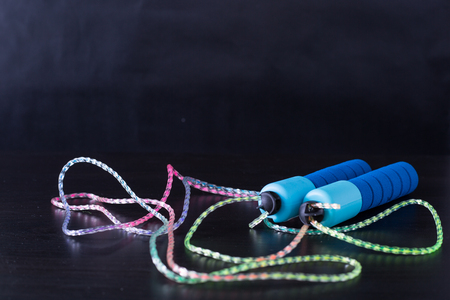 Blue skipping rope with black background.の写真素材