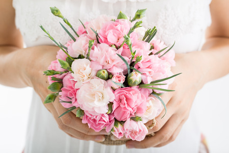Wedding flowers ,Woman holding colorful bouquet with her hands on wedding dayの写真素材