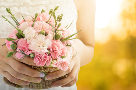 Mothers day ,woman holding blooming carnation flowers in the garden.の写真素材