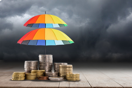 Colorful umbrella for saving money. Protection investment concept.の写真素材