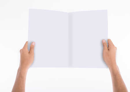 Holding blank white paper book with isolated white background.の写真素材