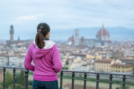 Woman standing front of Florence city view duomo landmark の写真素材