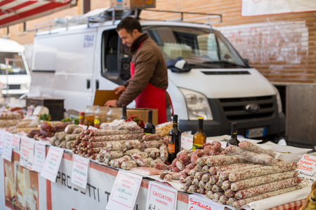 MILAN ,ITLAY - Oct 29 2016:Merchant preparing sausages product for sell to customer in Milan Market Italyのeditorial素材