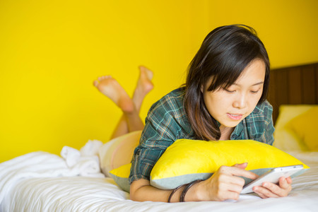Asian woman playing smartphone for search data and information.の写真素材