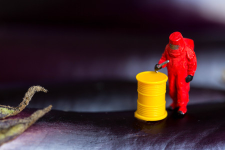 Protective suit science  people inspecting food and fruit with food danger concept.の写真素材